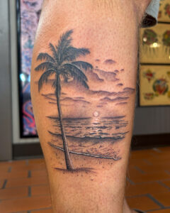 Sam Lott Brass Eagle Tattoo Peoria Black and Grey Realistic Beach Scene