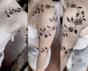 Zach Dole Brass Eagle Tattoo Peoria Feminine Flowers Wrapping Upper Arm